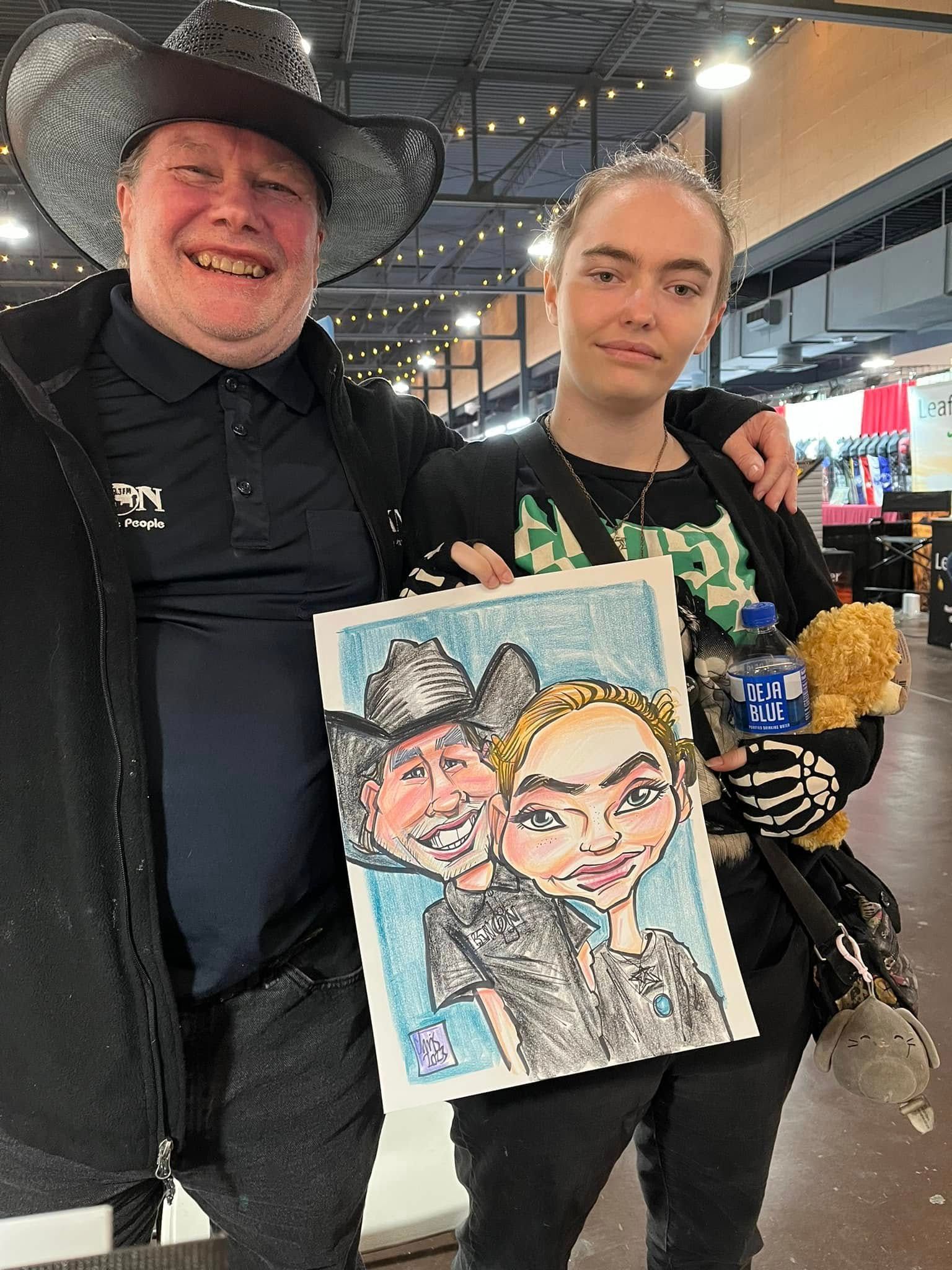 Two people at an indoor event hold a colorful caricature portrait drawing.