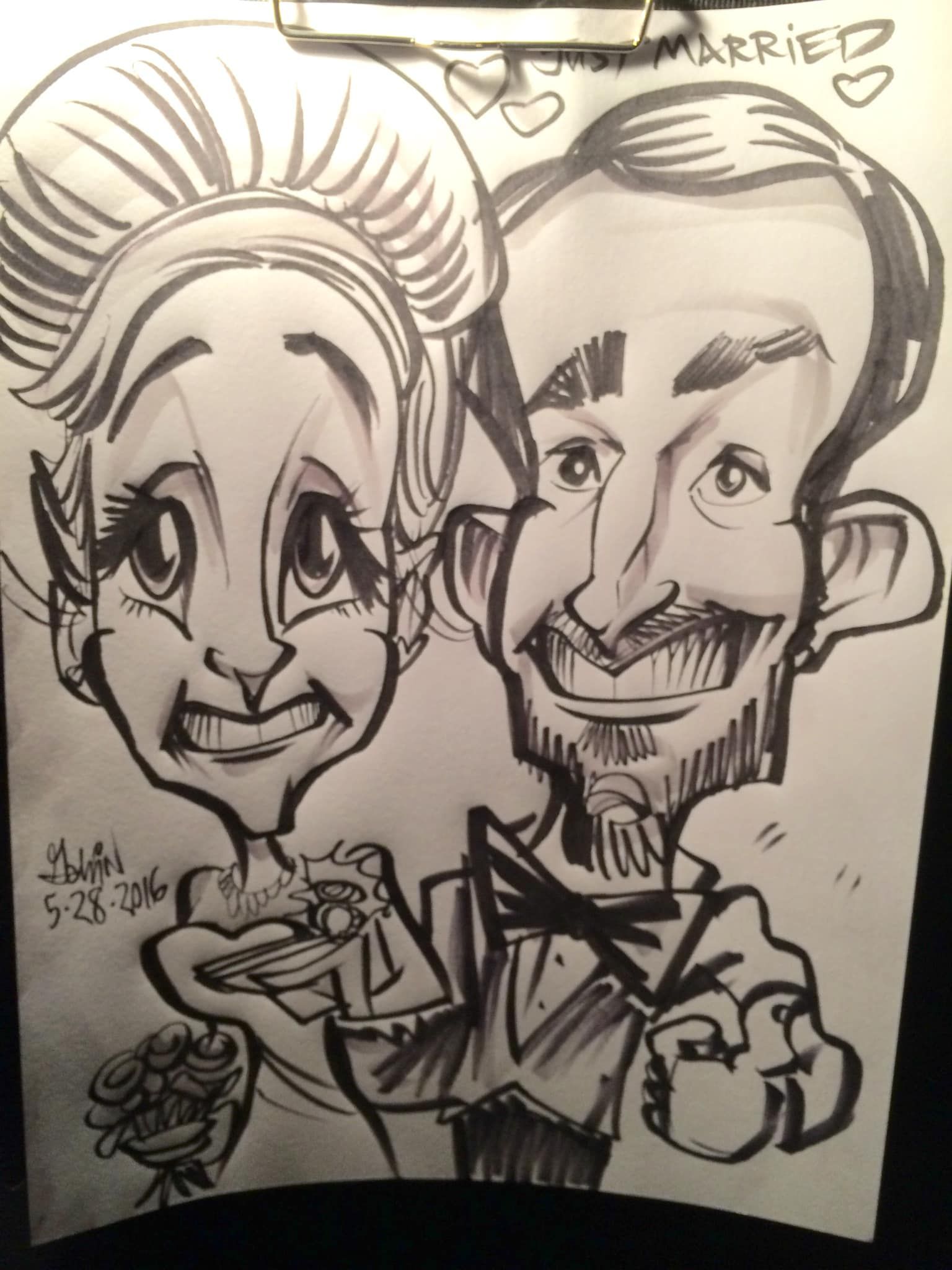 Black-and-white caricature of a smiling couple holding a drink and bouquet, with “married” written above.