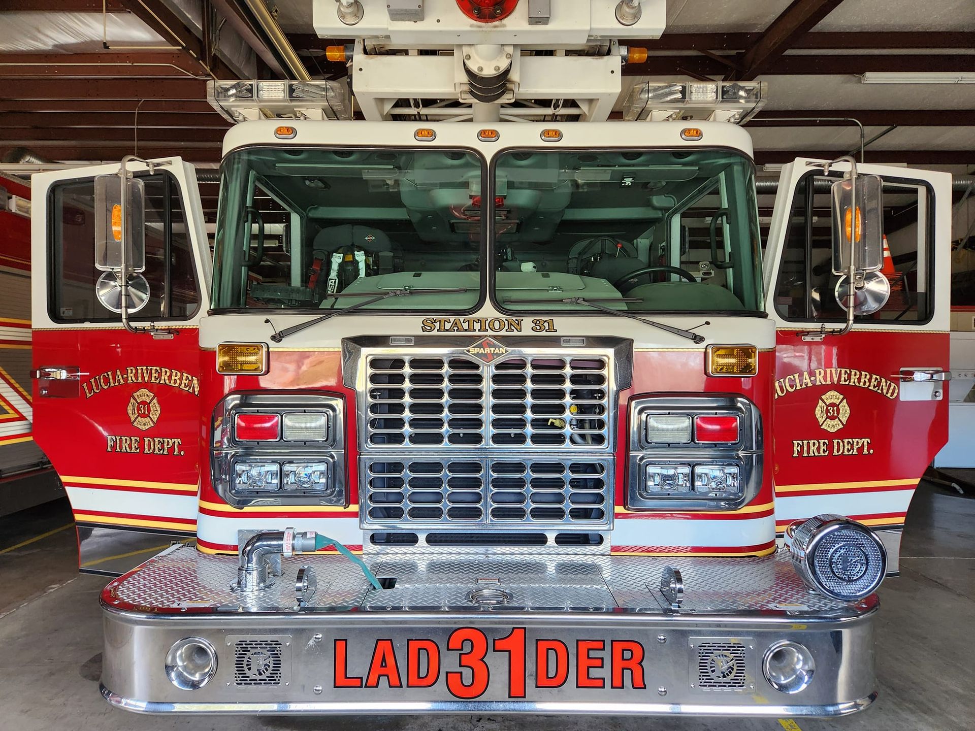 A red and white fire truck with the number 31 on the front