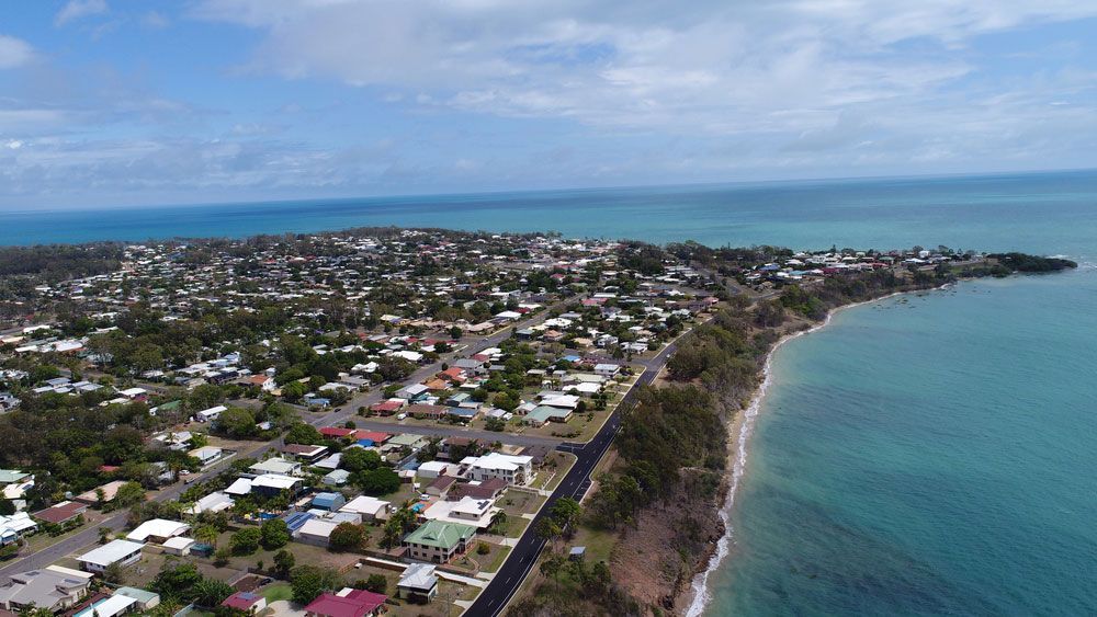 An Aerial View of a Small Town Next to a Body of Water — Active Tree Fellas in Hervey Bay, QLD