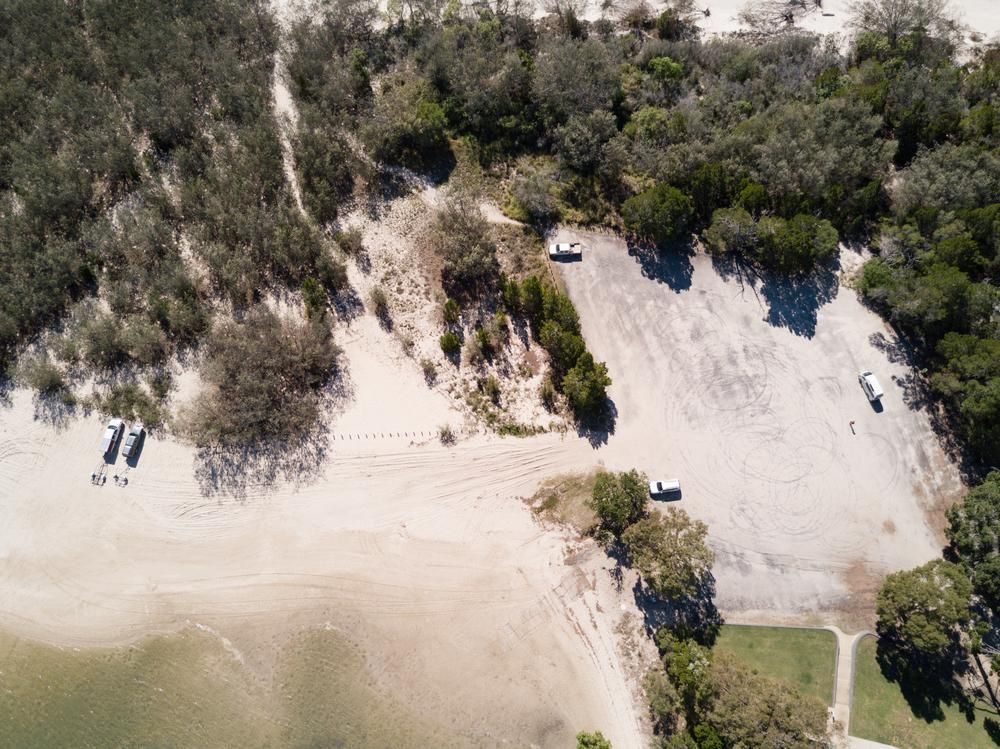 An Aerial View of a Parking Lot Next to a Beach — Active Tree Fellas in Woodgate, QLD