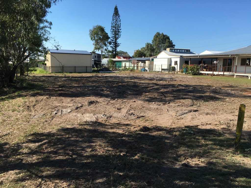 A Dirt Field With a House in the Background — Active Tree Fellas in Burrum Heads, QLD