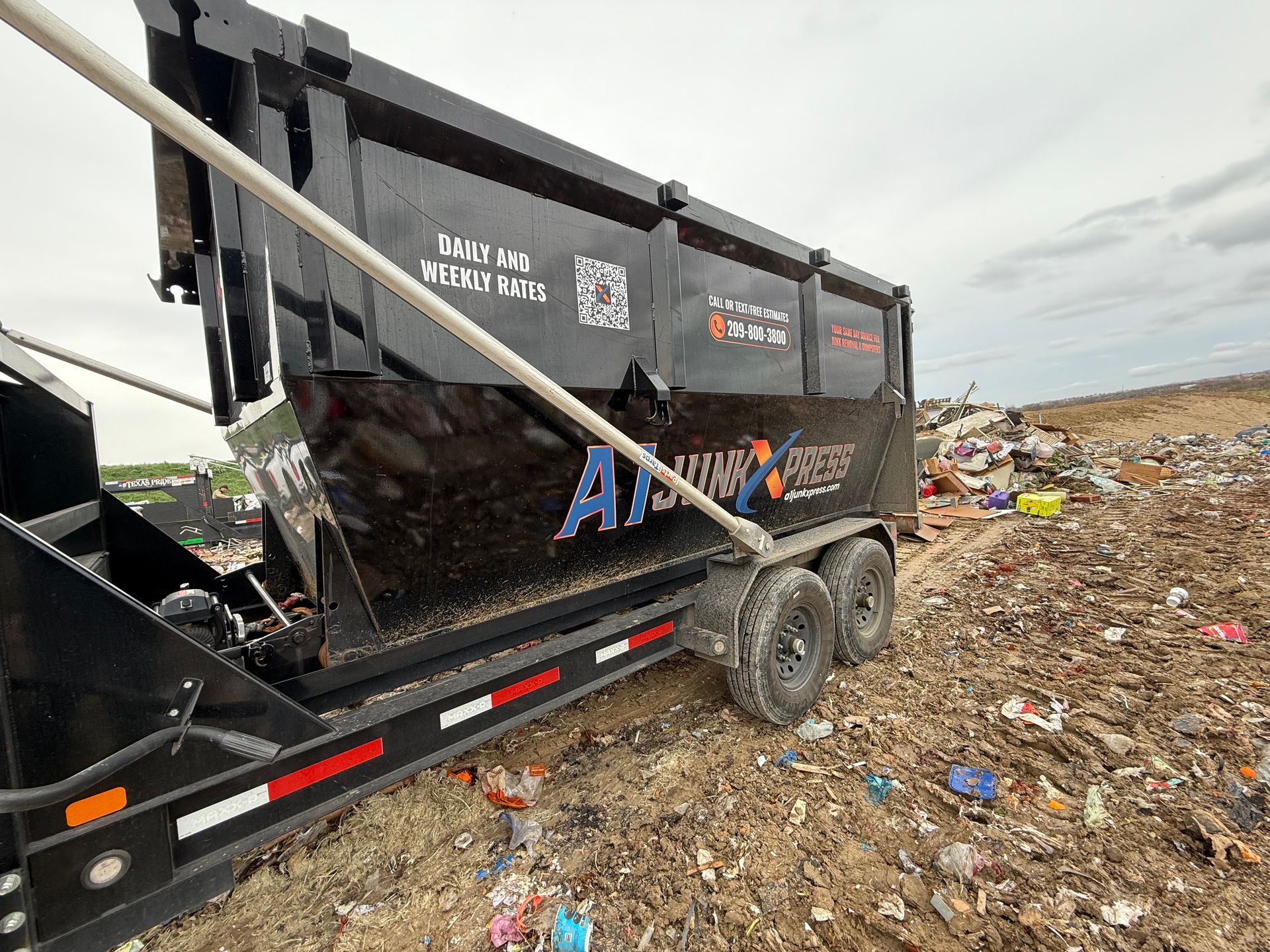 A black dump trailer branded 