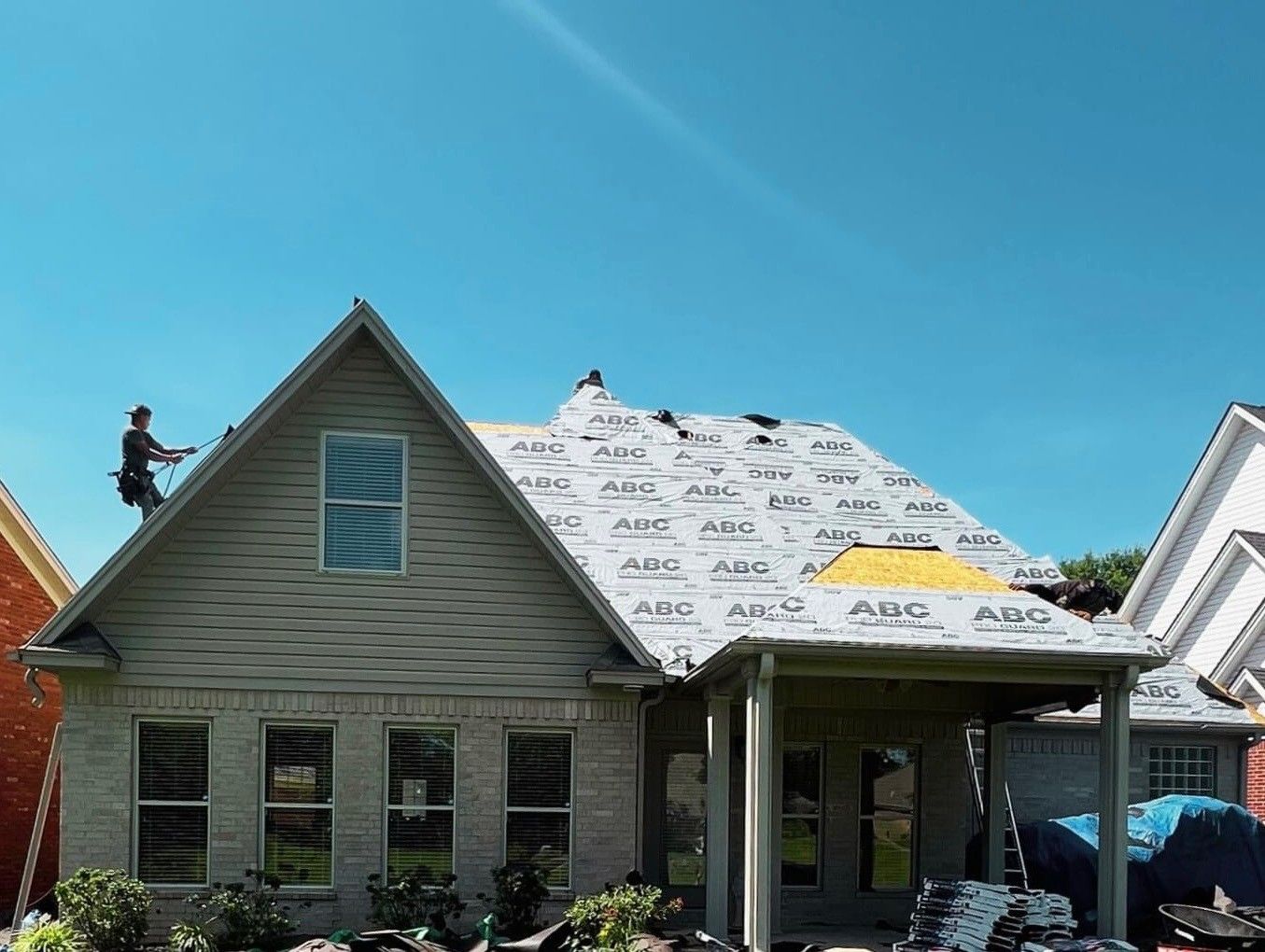 A man is working on the roof of a building