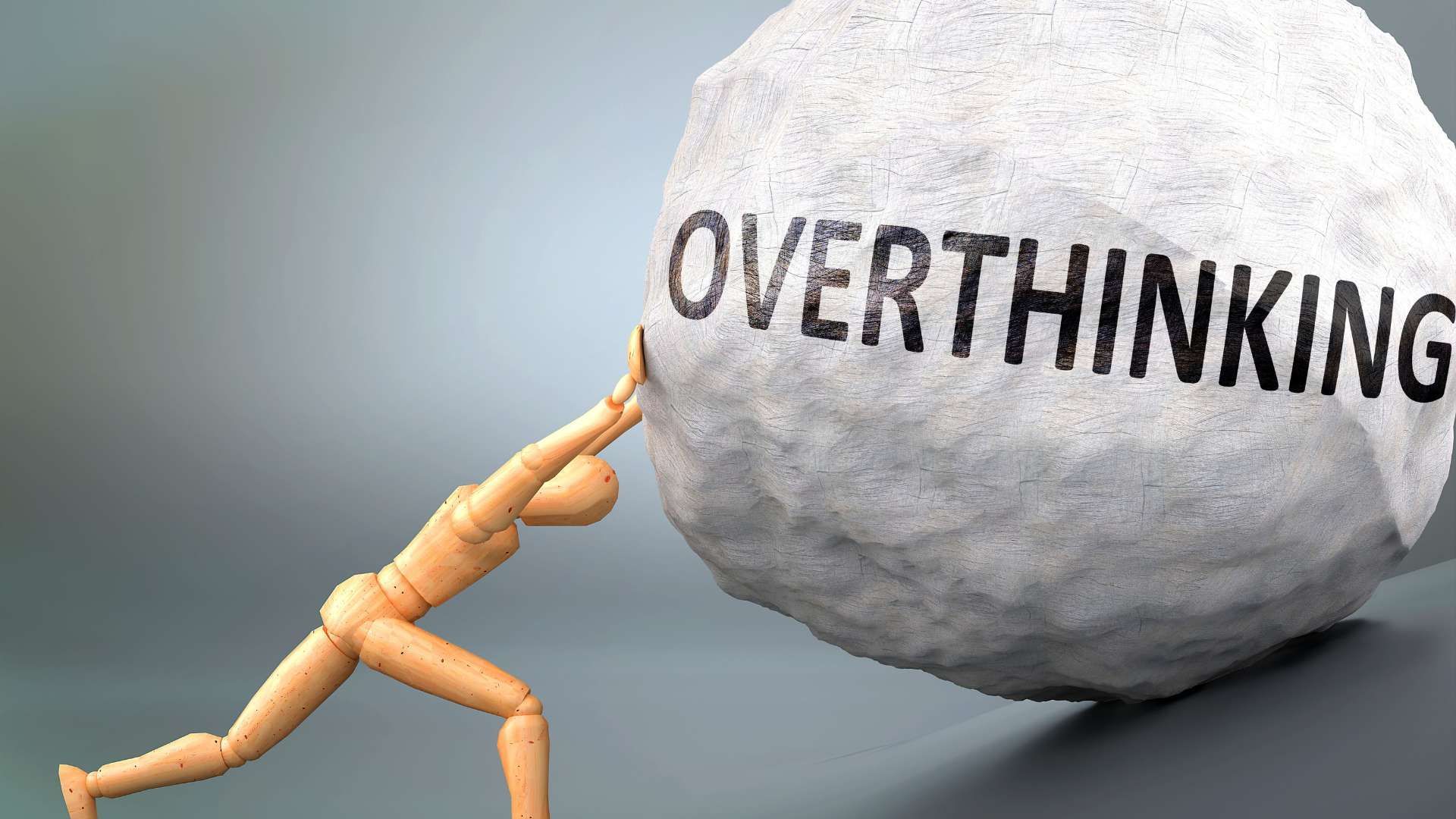 Wooden figure pushing a large gray boulder labeled “OVERTHINKING”