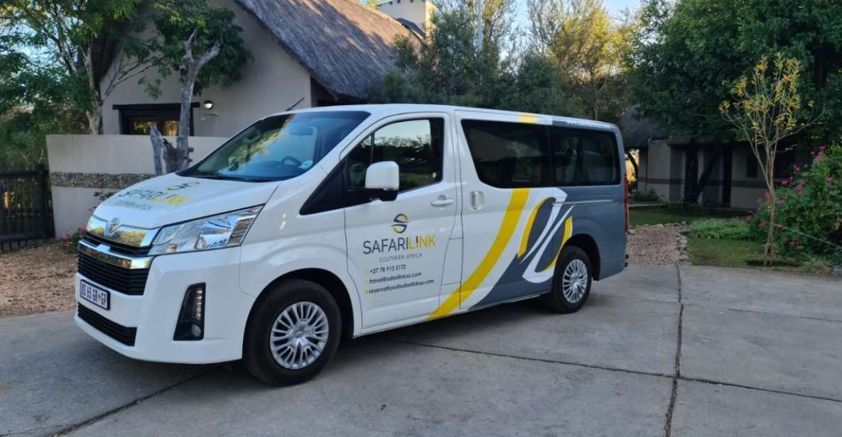 A white van with yellow stripes is parked in front of a house.
