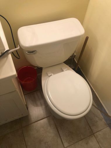 Plumber clearing a clogged drain