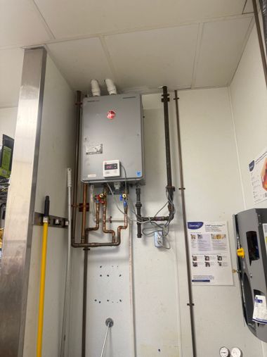 Plumber inspecting a water heater