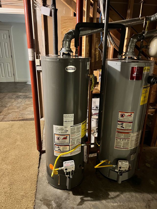 Plumber installing a water heater in a utility room.
