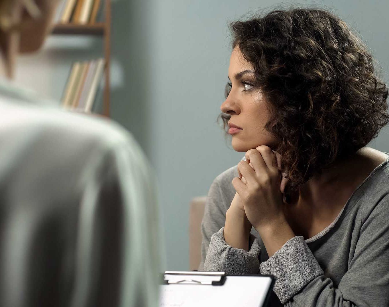 Depressed lady attending therapy session with psychologist, depressive state