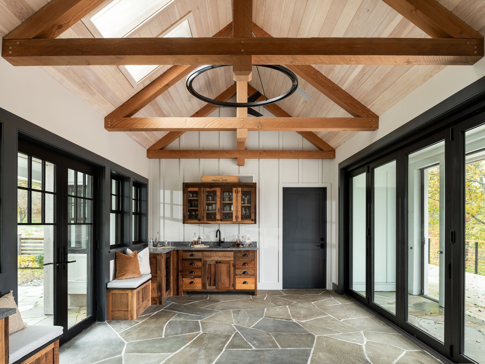 A large room with a lot of windows and wooden beams.