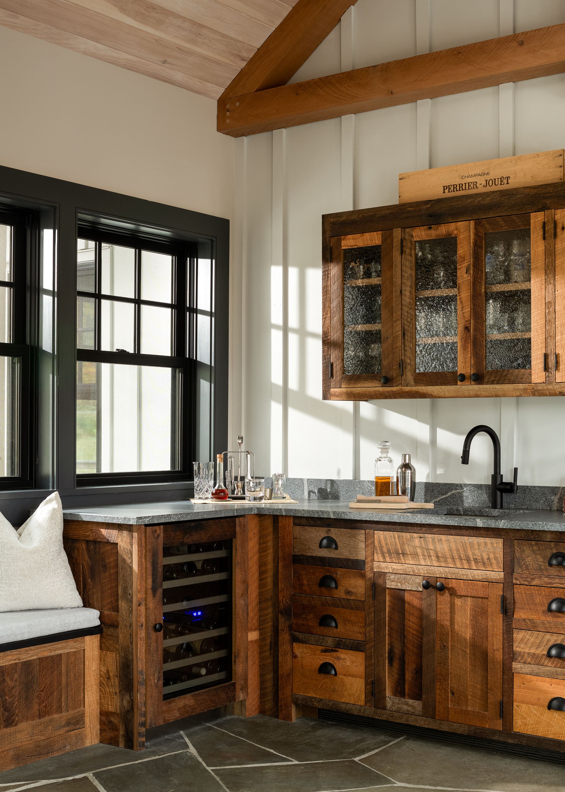 A kitchen with wooden cabinets and a wine cooler