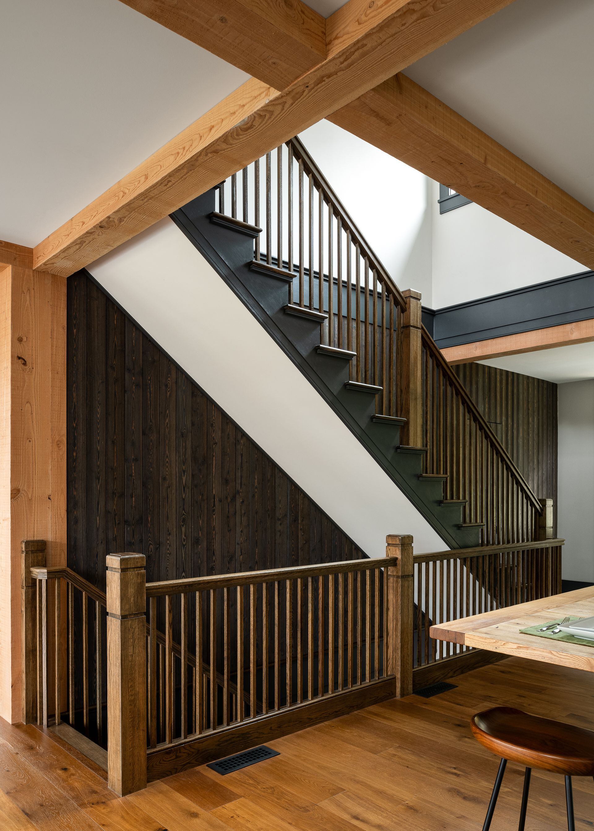 A wooden staircase in a house with a wooden railing