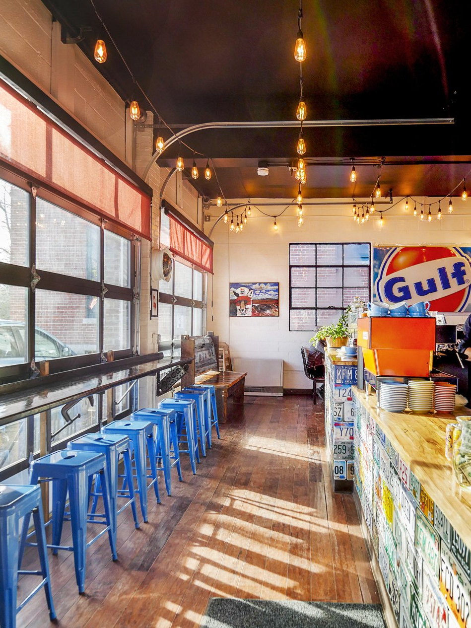A restaurant with blue stools and a gulf sign on the wall.