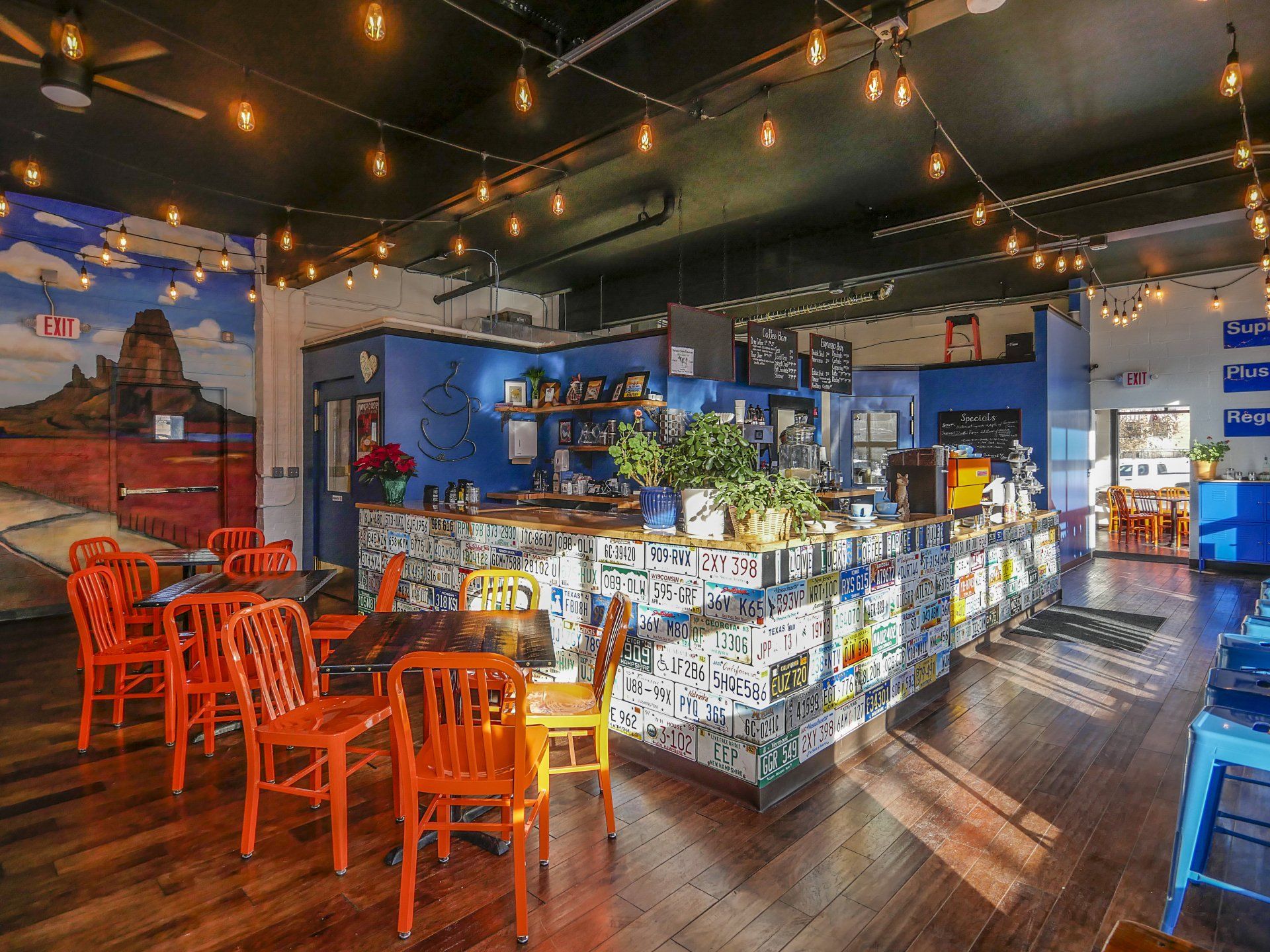 A restaurant with tables and chairs and a bar.