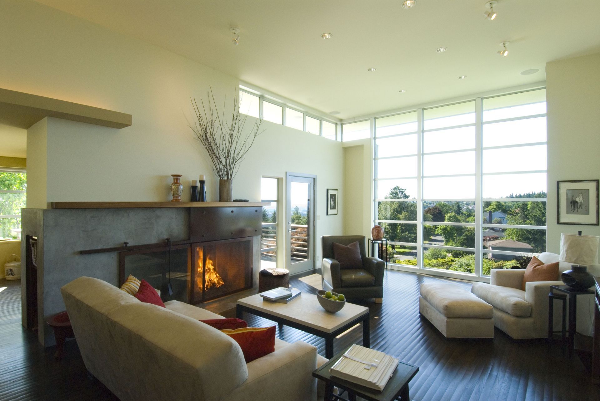 A living room with a fireplace and lots of windows