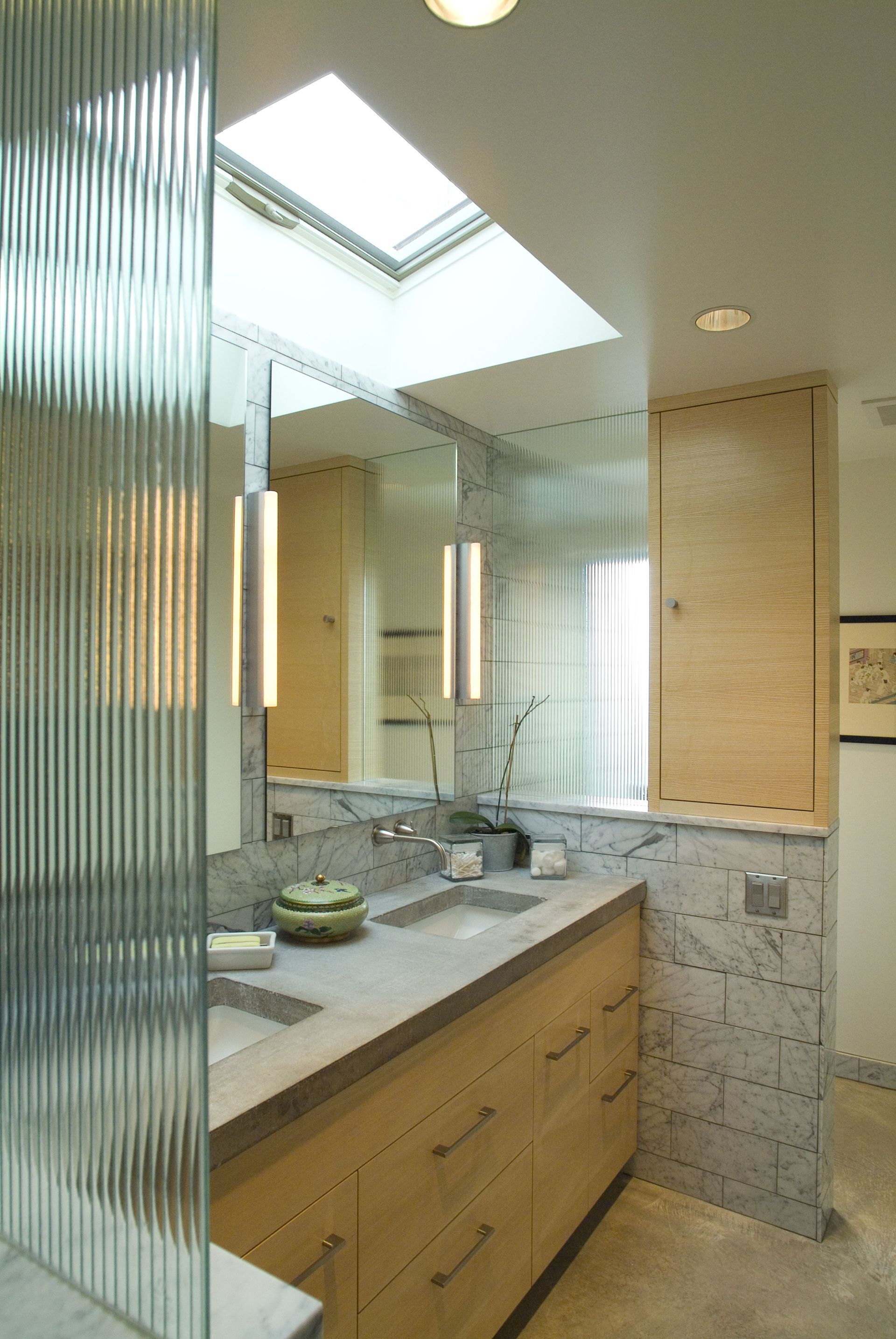 A bathroom with a skylight above the sink