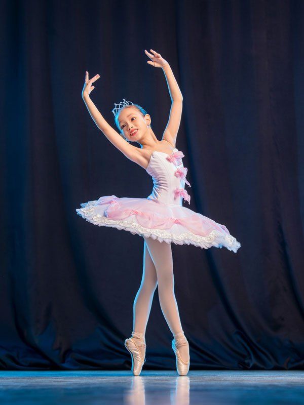 A Little Girl Ballerina is Dancing on Stage — Port Stephens — Robyn Yvette Dance Centre A Little Girl Ballerina is Dancing on Stage — Port Stephens — Robyn Yvette Dance Centre