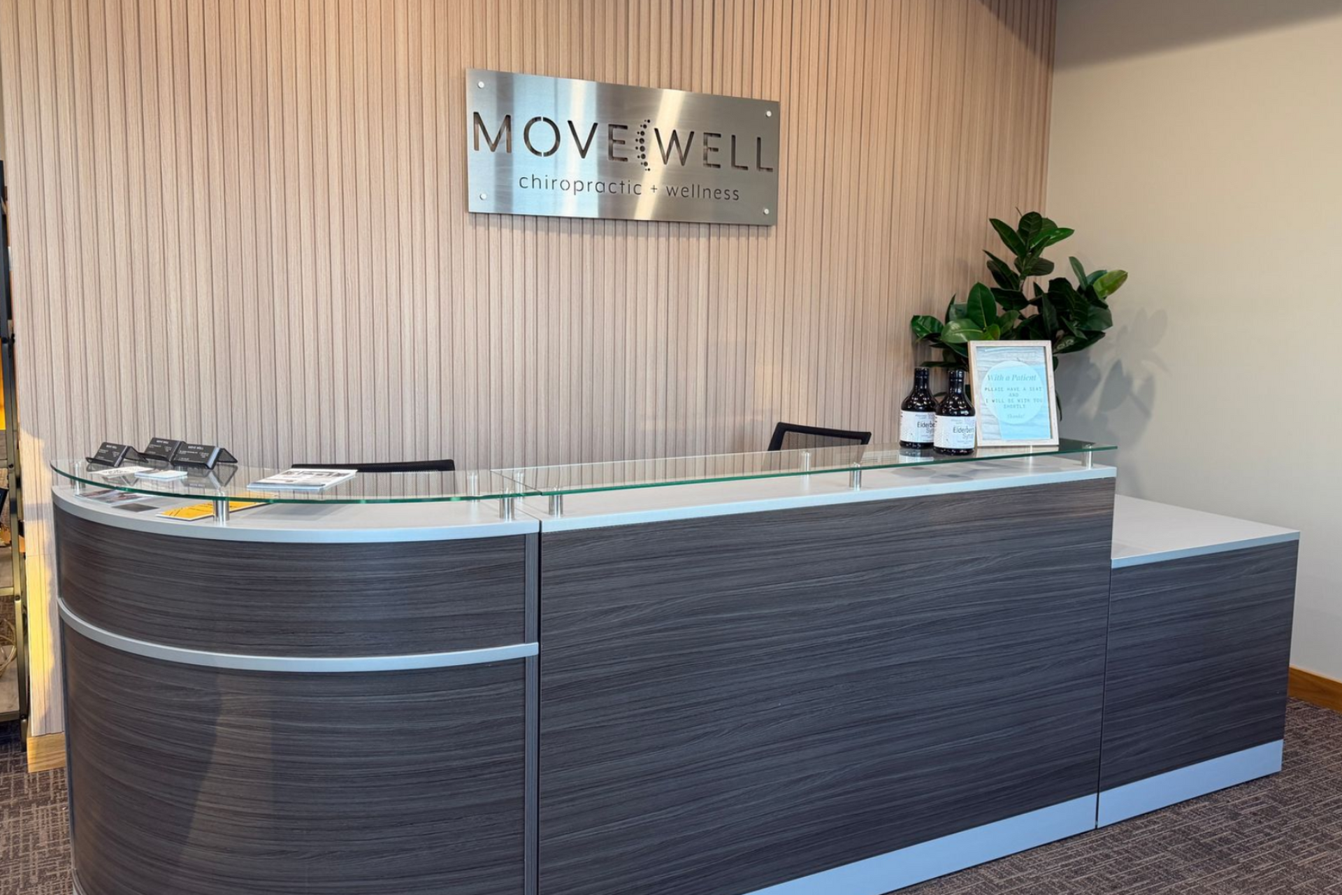 Reception desk with a stone facade, wooden accent wall, and 