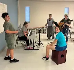 a group of people are playing instruments in a room .