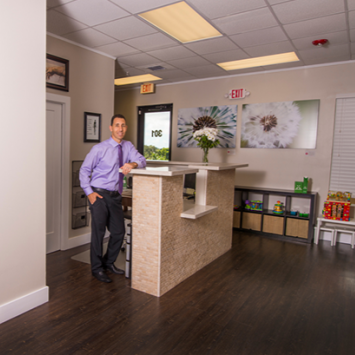 Reception area with a man leaning on a front desk in a modern office lobby