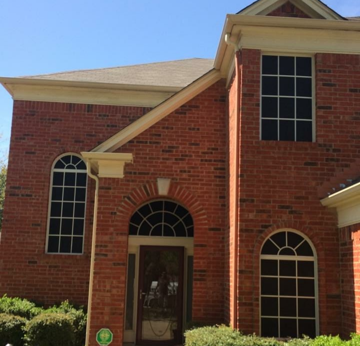 A large red brick house with arched windows