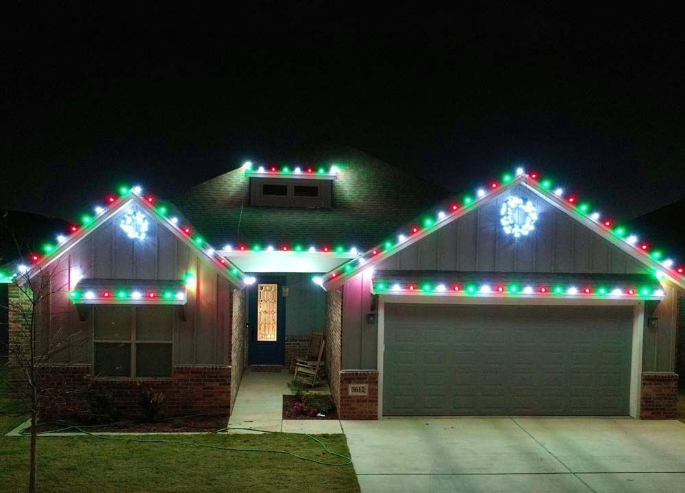 House decorated with colorful Christmas lights at night