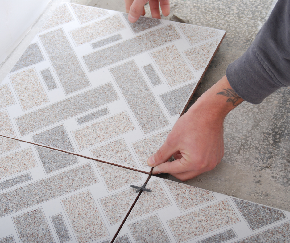 A person is laying a tile on the floor