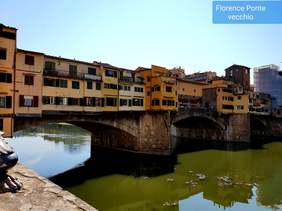 Ponte Vecchio, Florence, Italië, middeleeuwse stenen brug met winkels en gebouwen over een rivier. Zonnige dag.