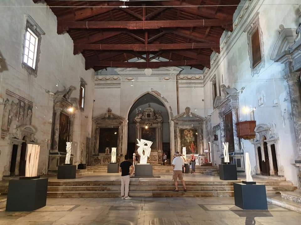 Interieur van een historisch gebouw met tentoongestelde sculpturen Pietrasanta