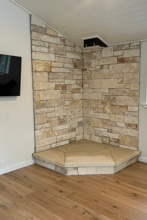 A living room with a fireplace and a flat screen tv