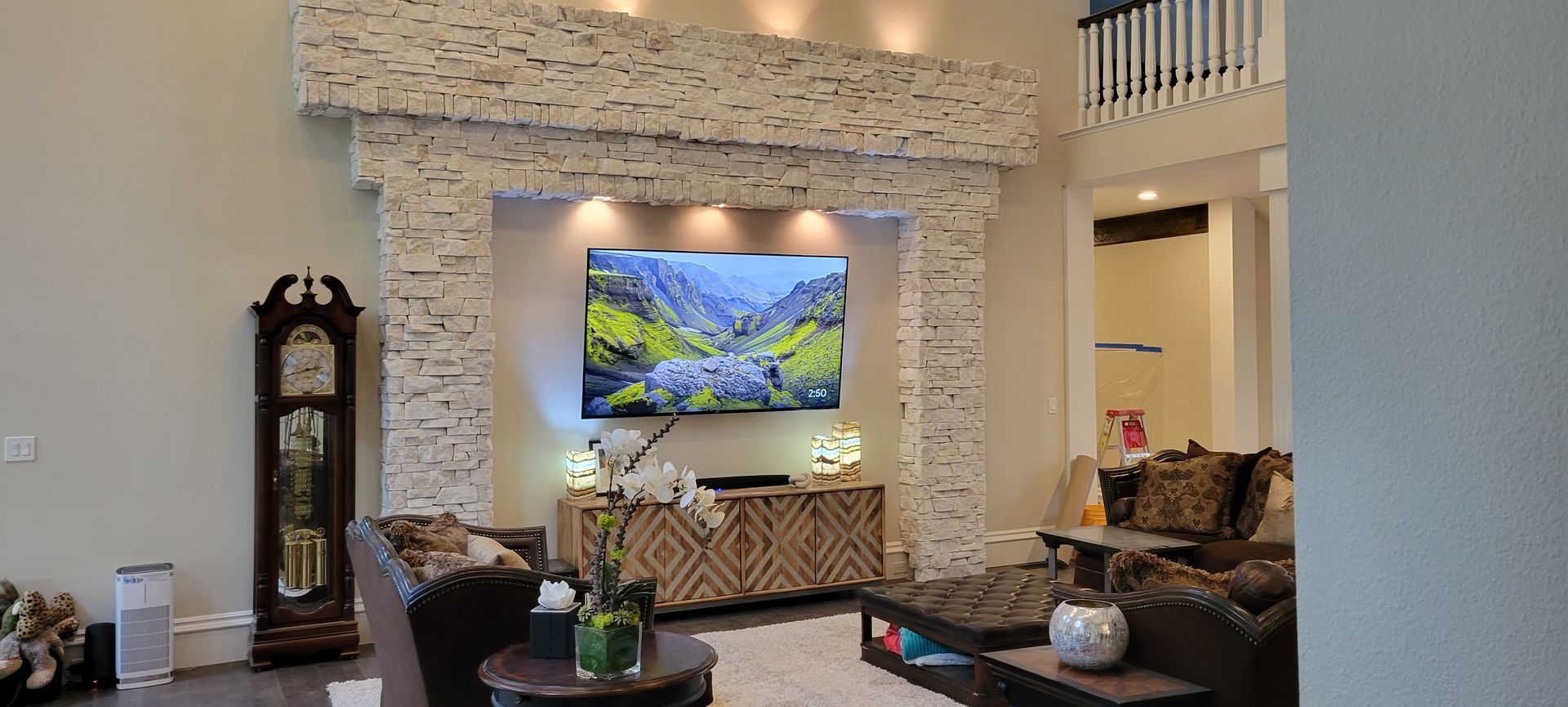 A living room with a clock and a flat screen tv on the wall