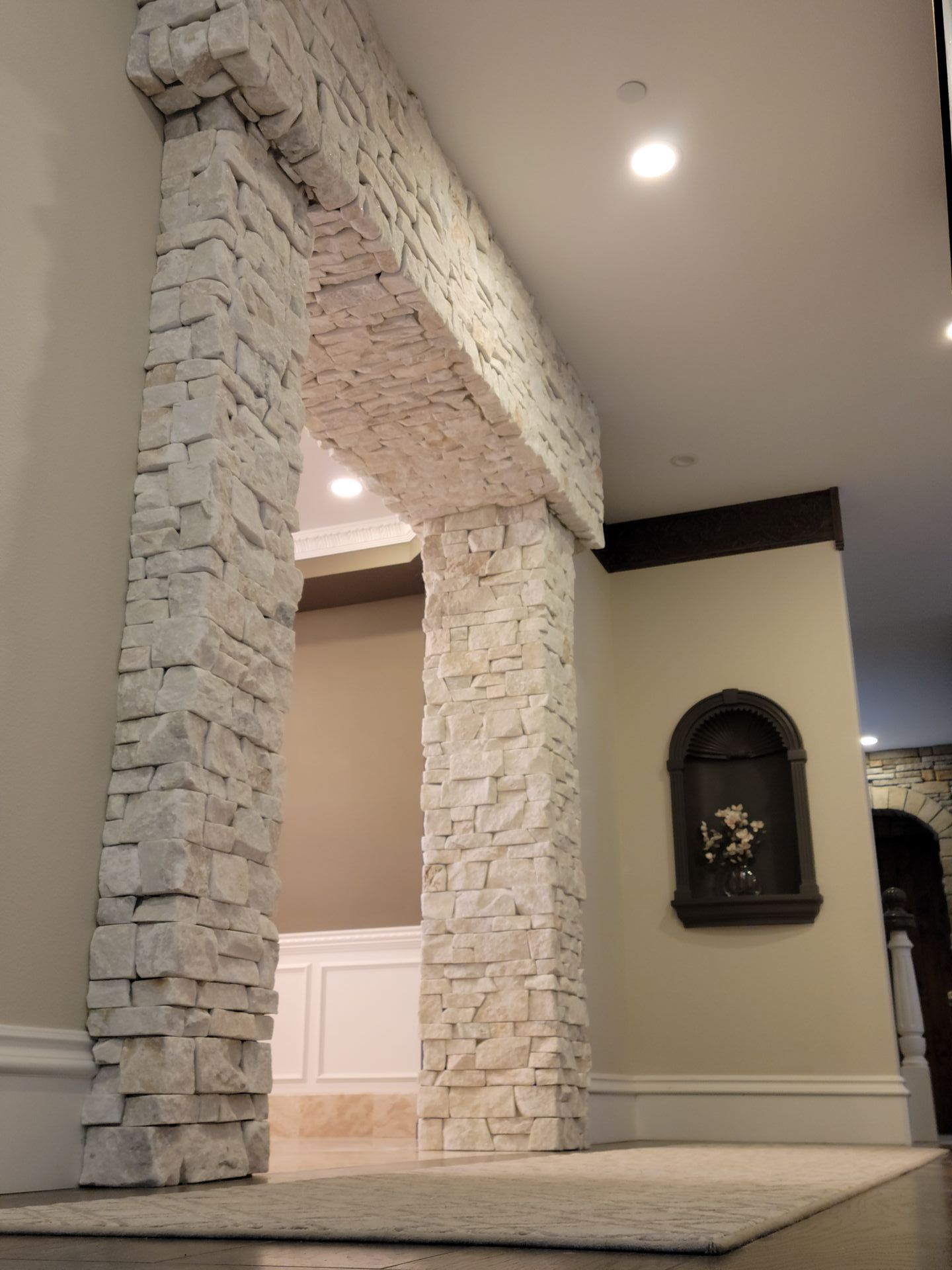 There is a stone archway in the middle of the room