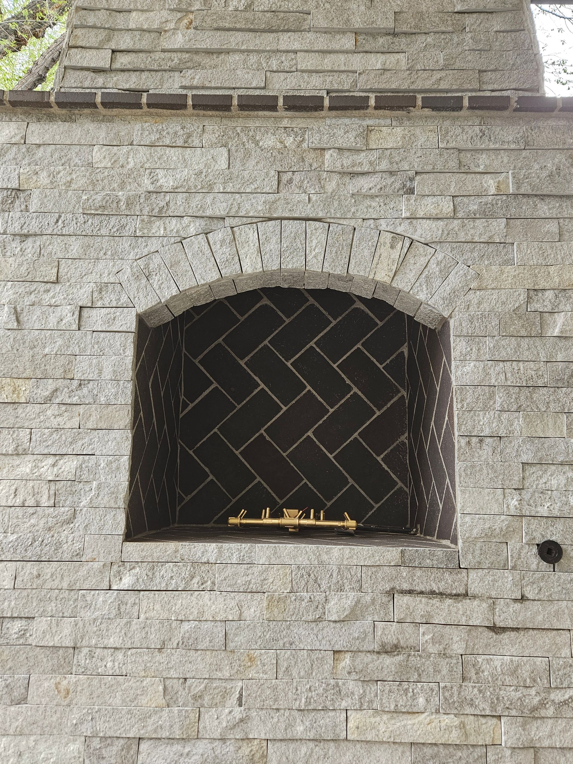 A brick wall with a fireplace in it