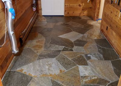 A hallway with a tiled floor and wooden walls
