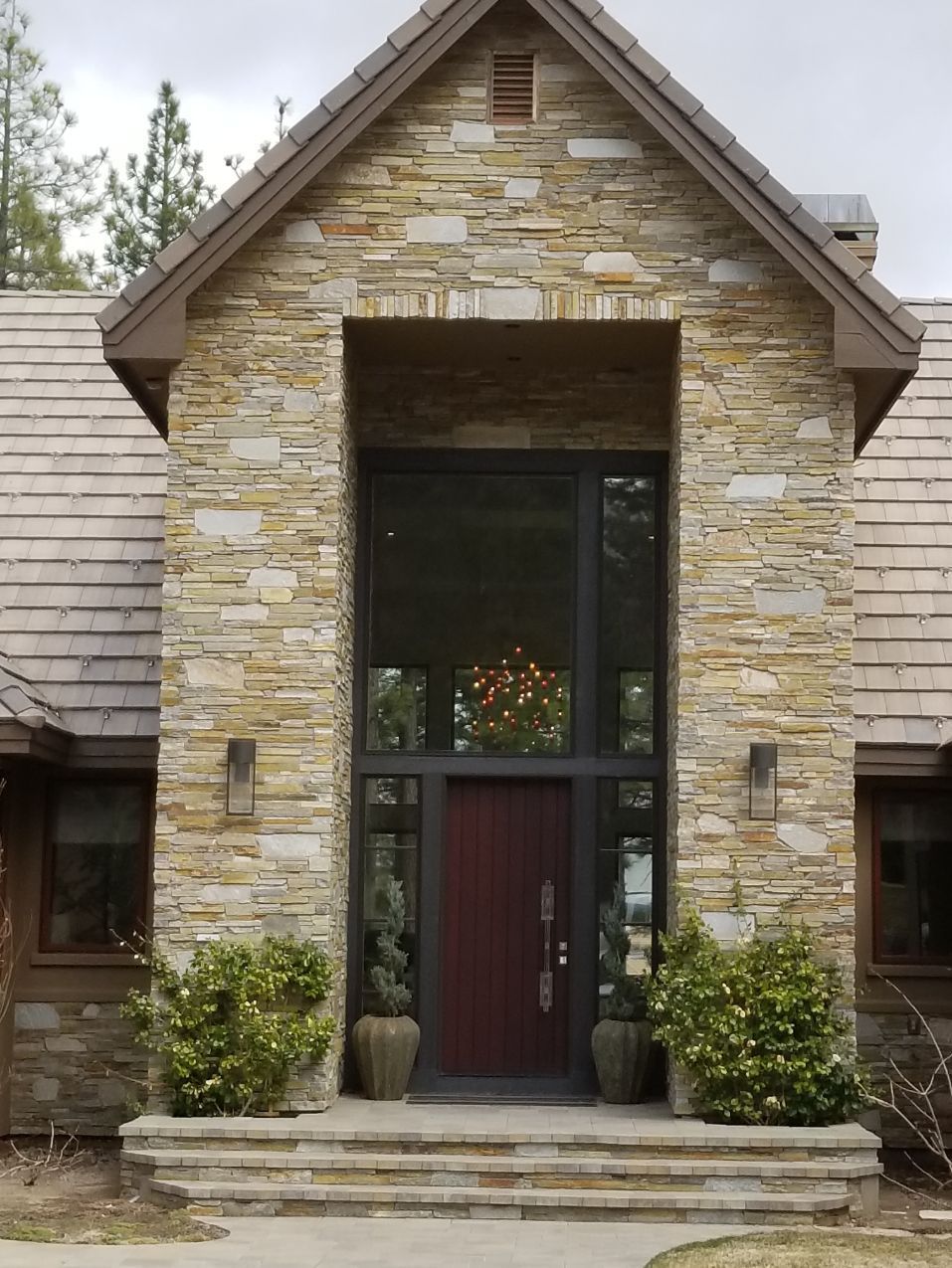 A large stone house with a red door
