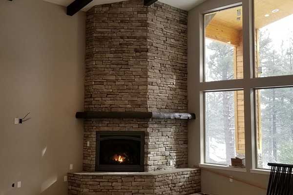 There is a fireplace in the corner of the room