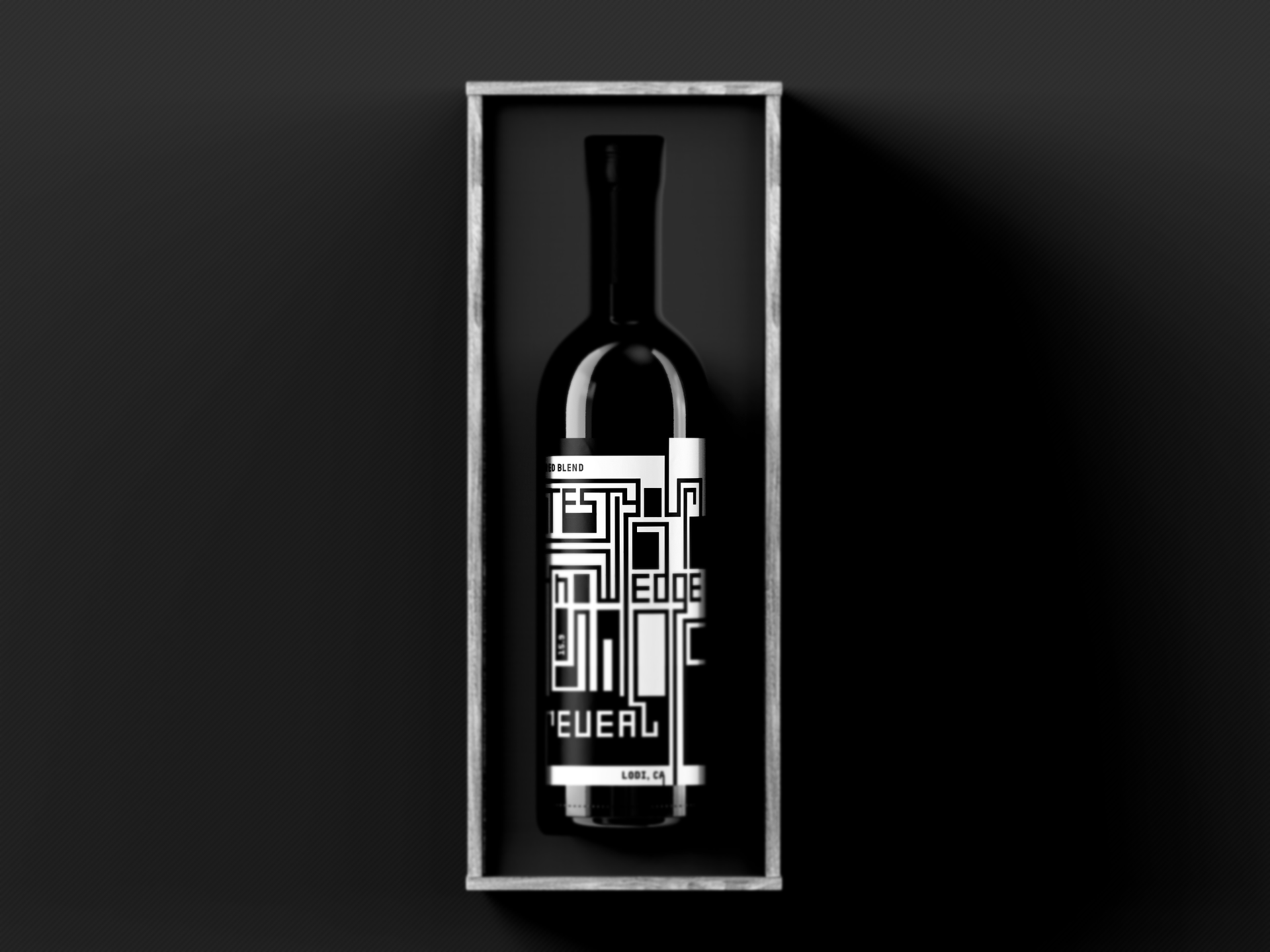 Black wine bottle with white label, in a silver box on a black surface.