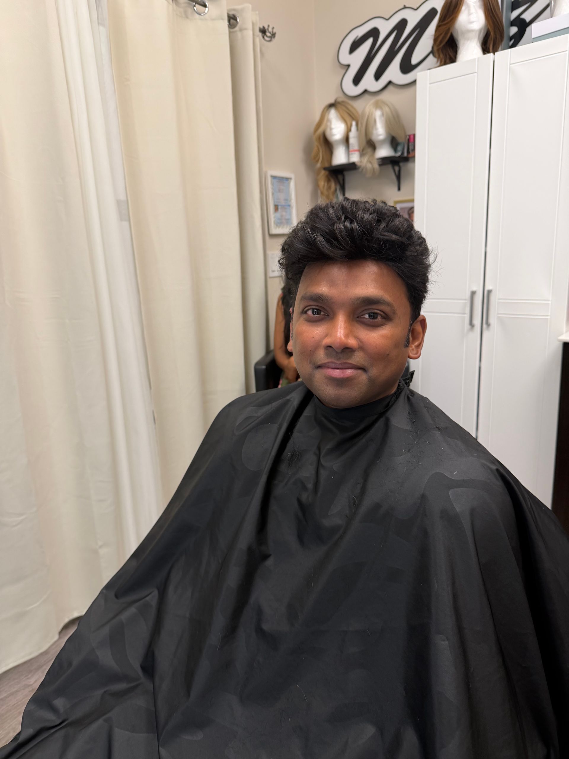 Close-up of shoulder-length, layered brown hair with caramel-toned highlights styled in a soft wave.