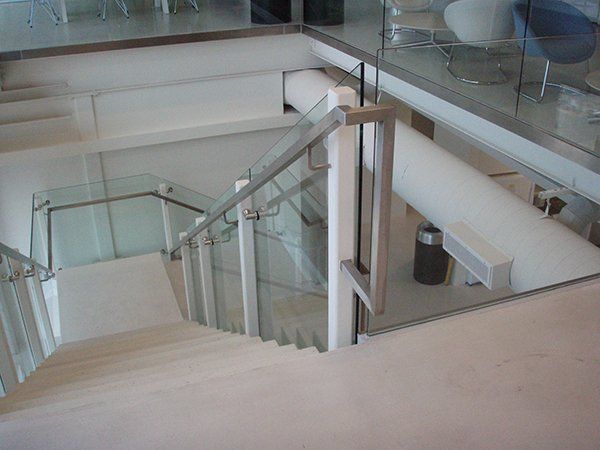 A Staircase with A Glass Railing Leading up To the Second Floor of A Building