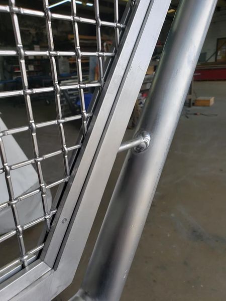 A Close Up Of a Metal Fence With A Window