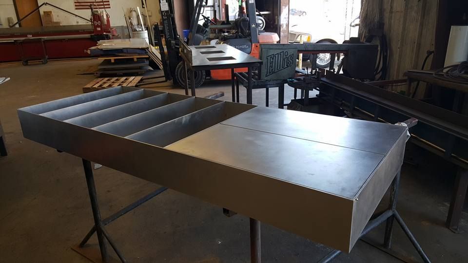 A Metal Tray Is Sitting on Top of A Metal Table in A Workshop