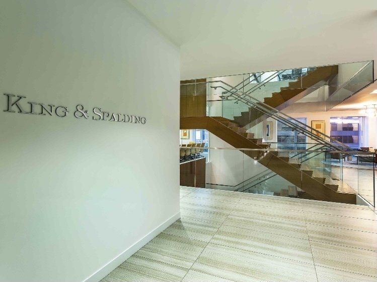 A Hallway with Stairs and A Sign that Says King & Spades