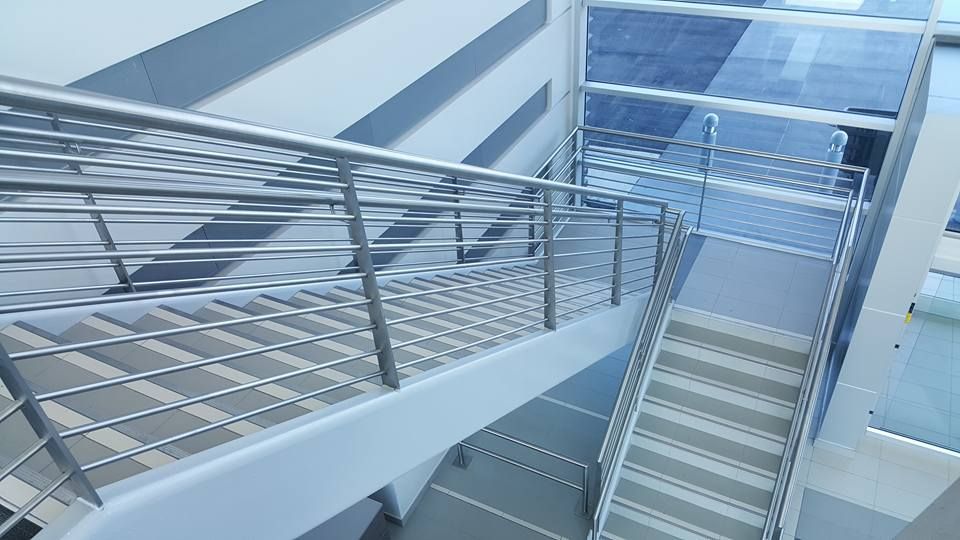 A Staircase in A Building with A Stainless Steel Railing