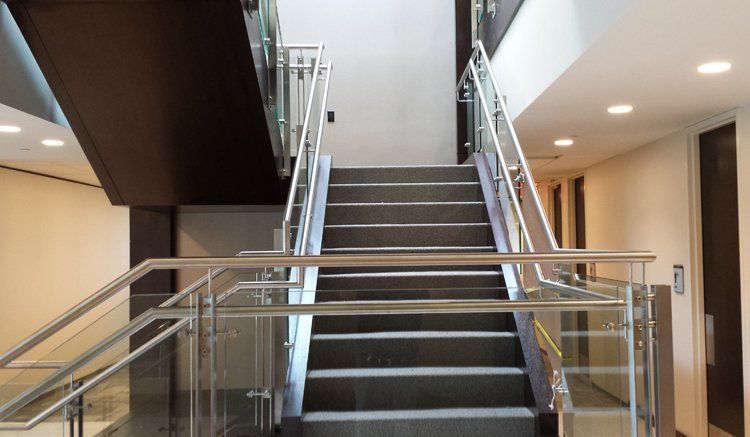 A Set of Stairs with A Glass Railing in A Building