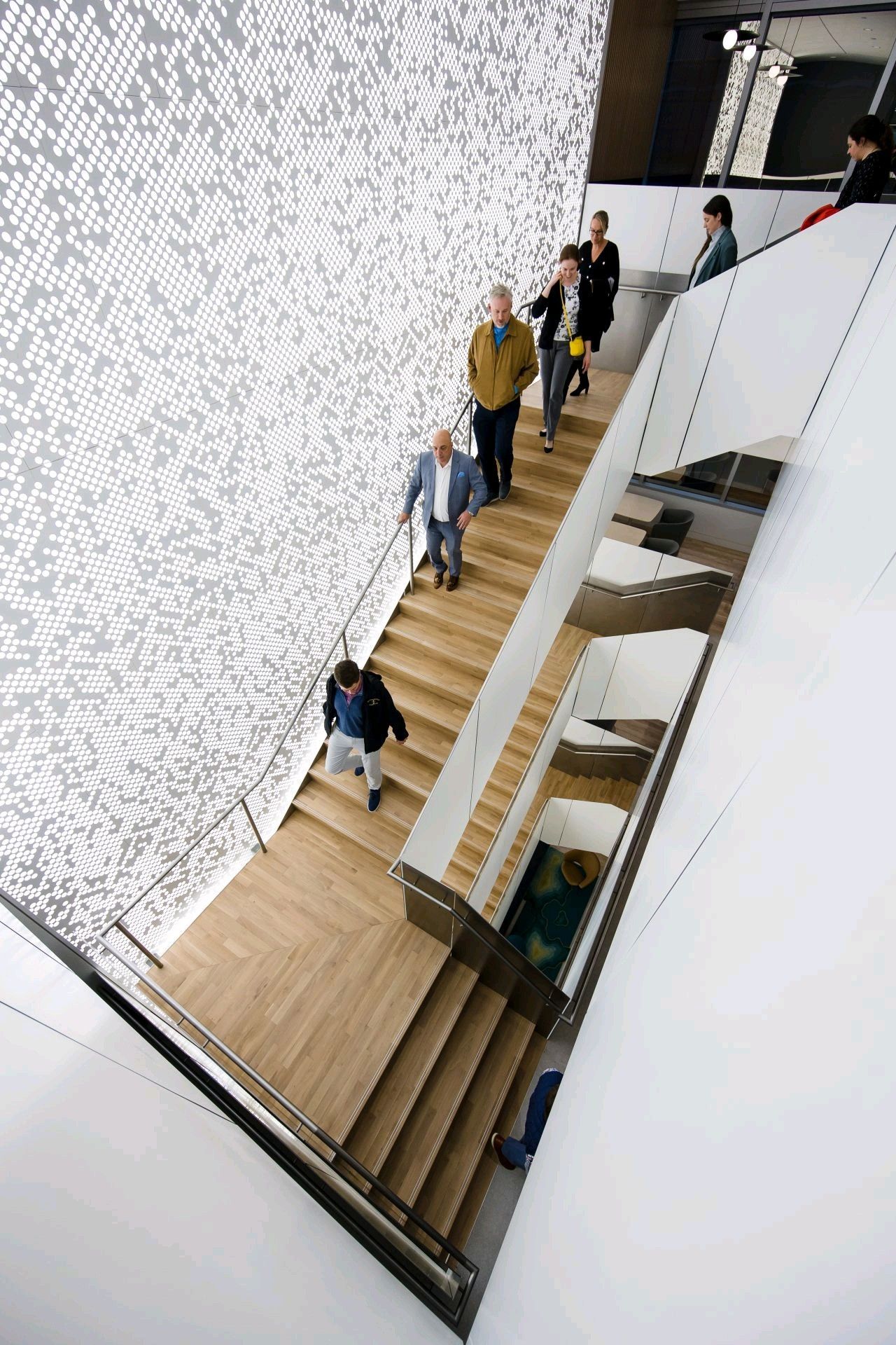 A group of people are walking down a set of stairs