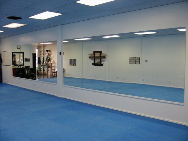 A large room with a lot of mirrors on the wall