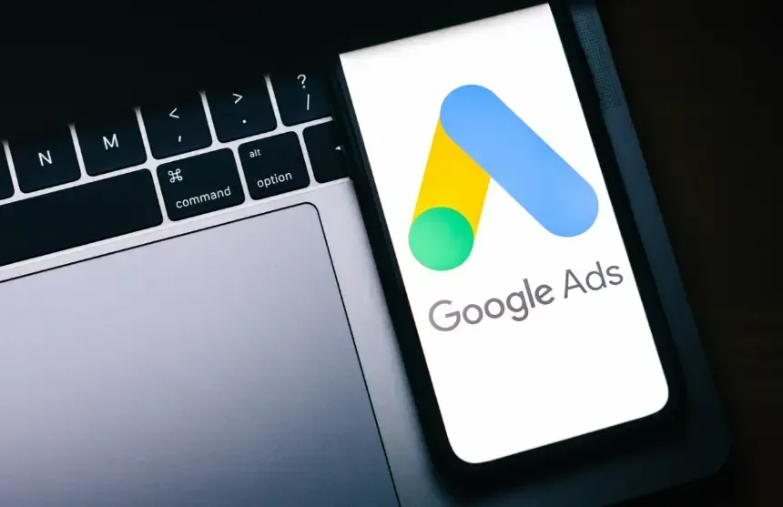 Cell phone on a computer keyboard displaying Google Ads. Florida Coast SEO provides Google Ads services.