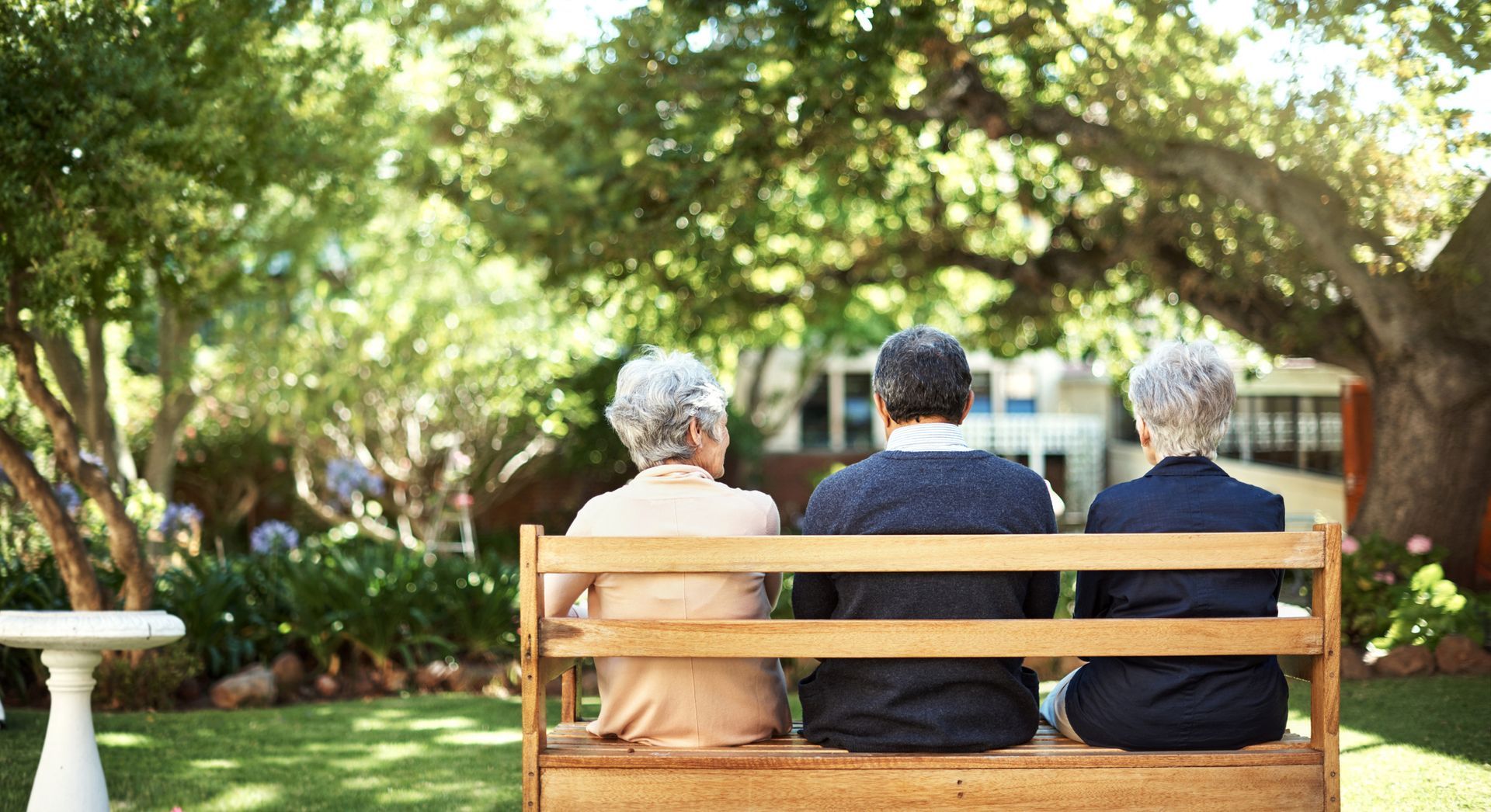 People Sitting on Bench — West Valley City, UT — American Heritage Retirement Community