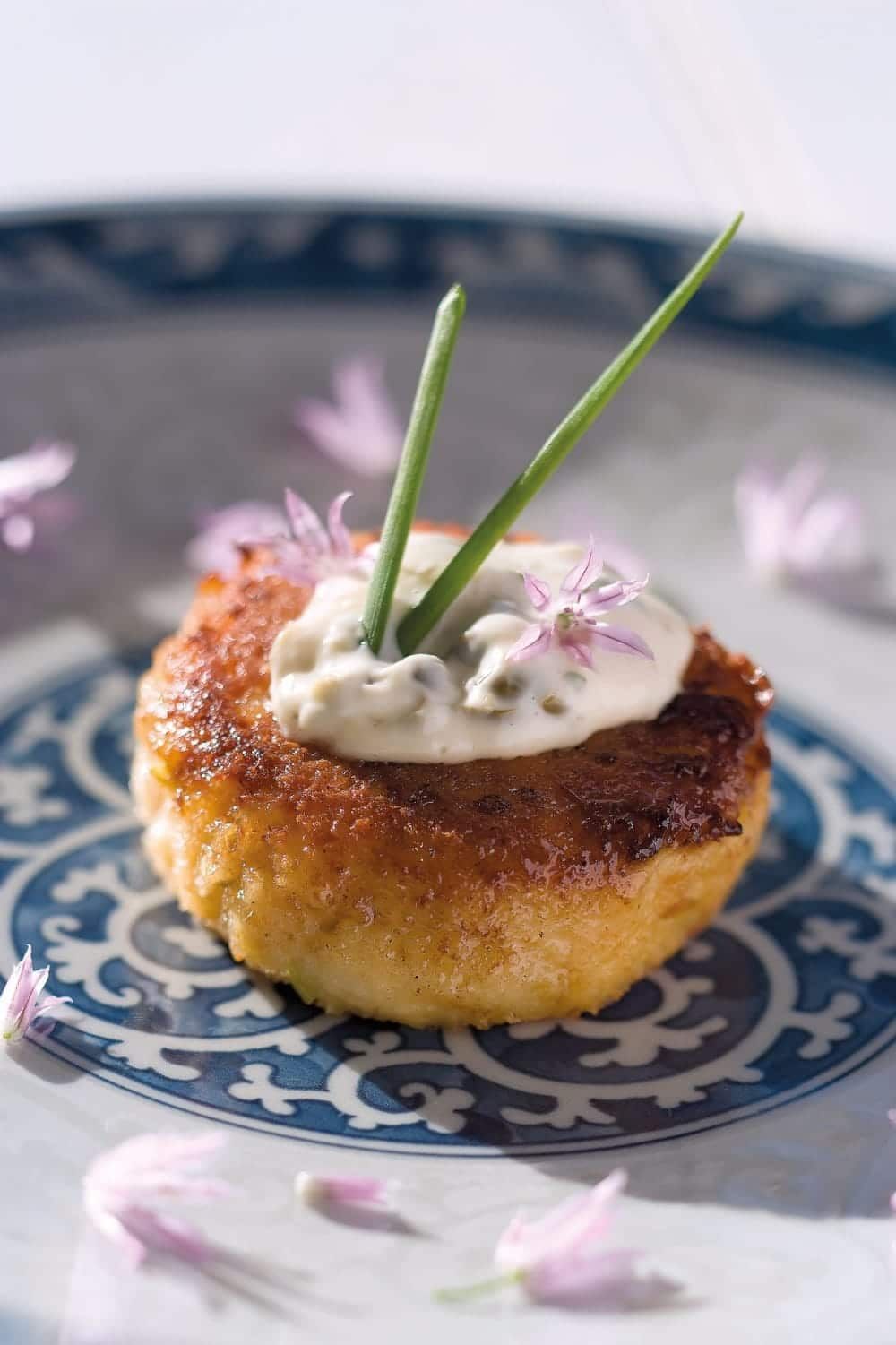A close up of a plate of food with flowers on it